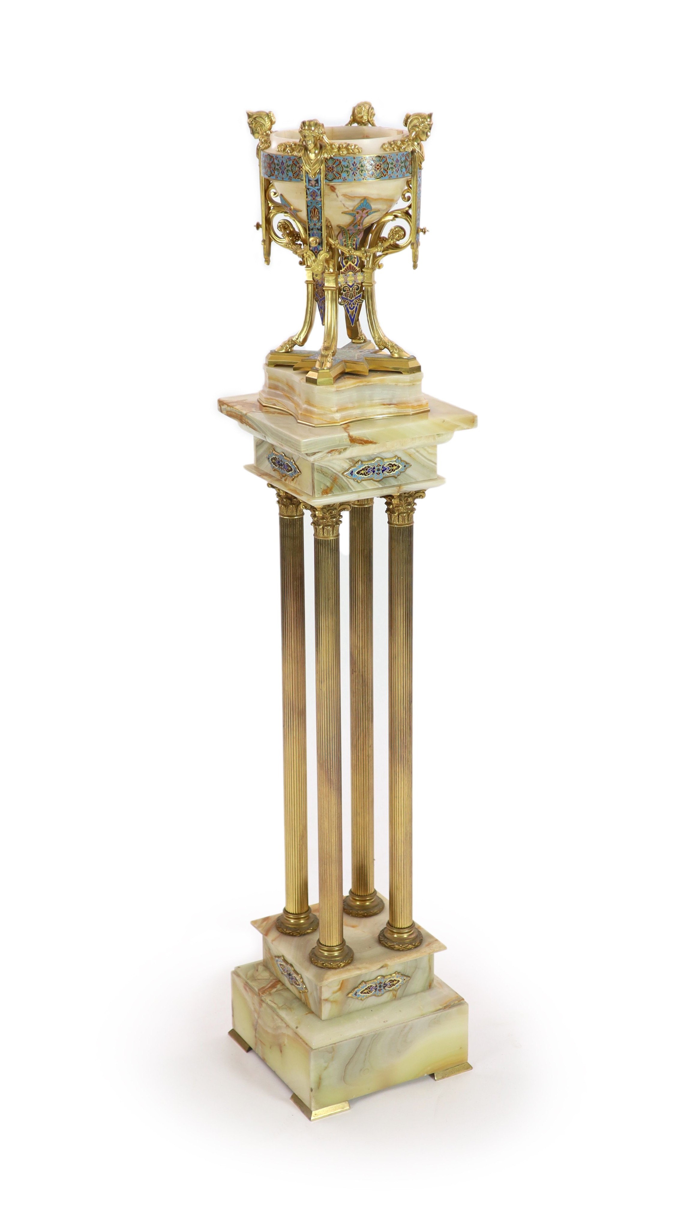 A pale cream onyx, gilt bronze and champlevé enamelled pedestal urn on swept supports with swag and satyr mask decoration and a similar onyx, gilt bronze and champlevé enamelled torchere Urn H 41cm. W 22cm. Pedestal H 10